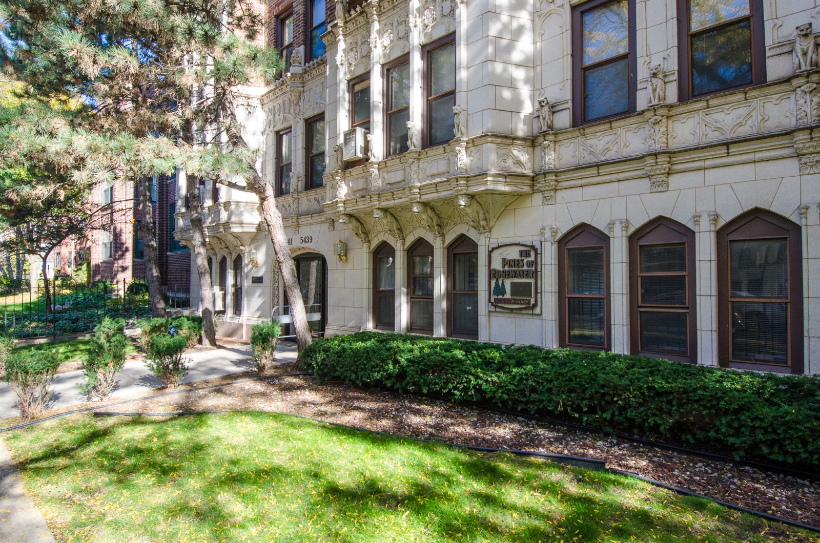 the exterior of a building with a lawn and trees